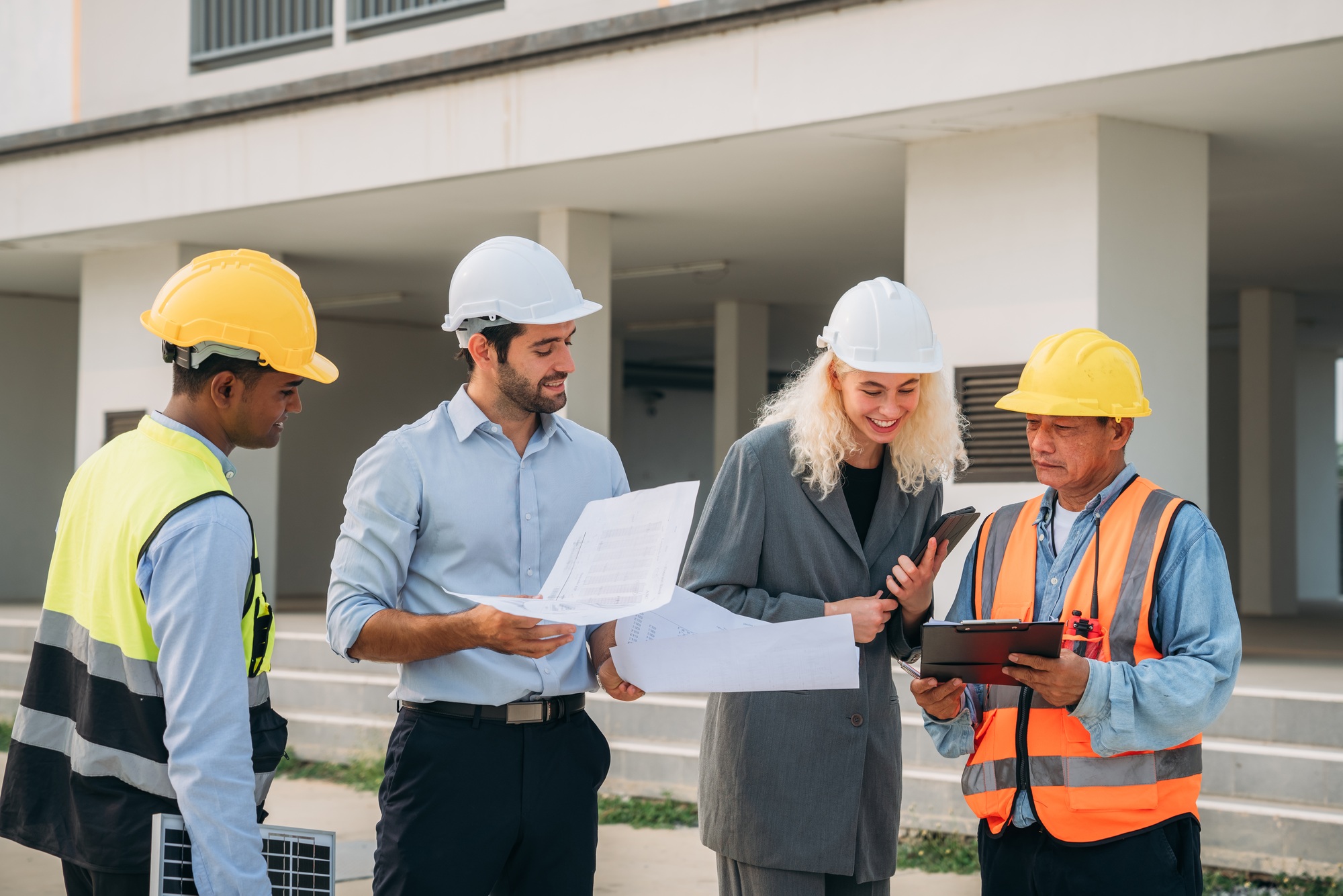 Team construction workers discussing project details.
